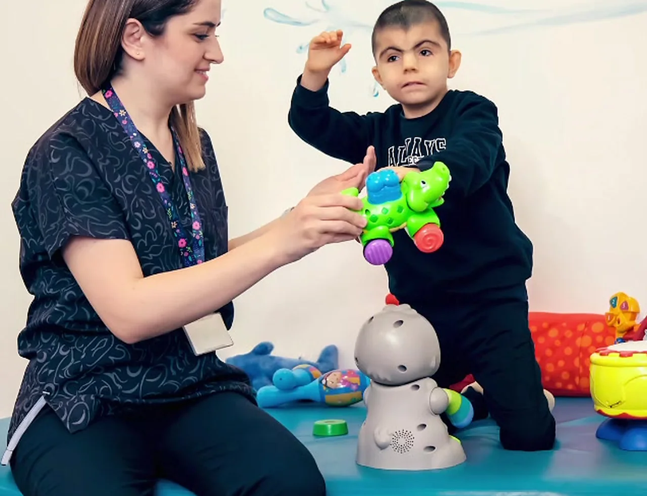 Paediatric therapist working with a young child in a bright therapy room in Keshav Puram